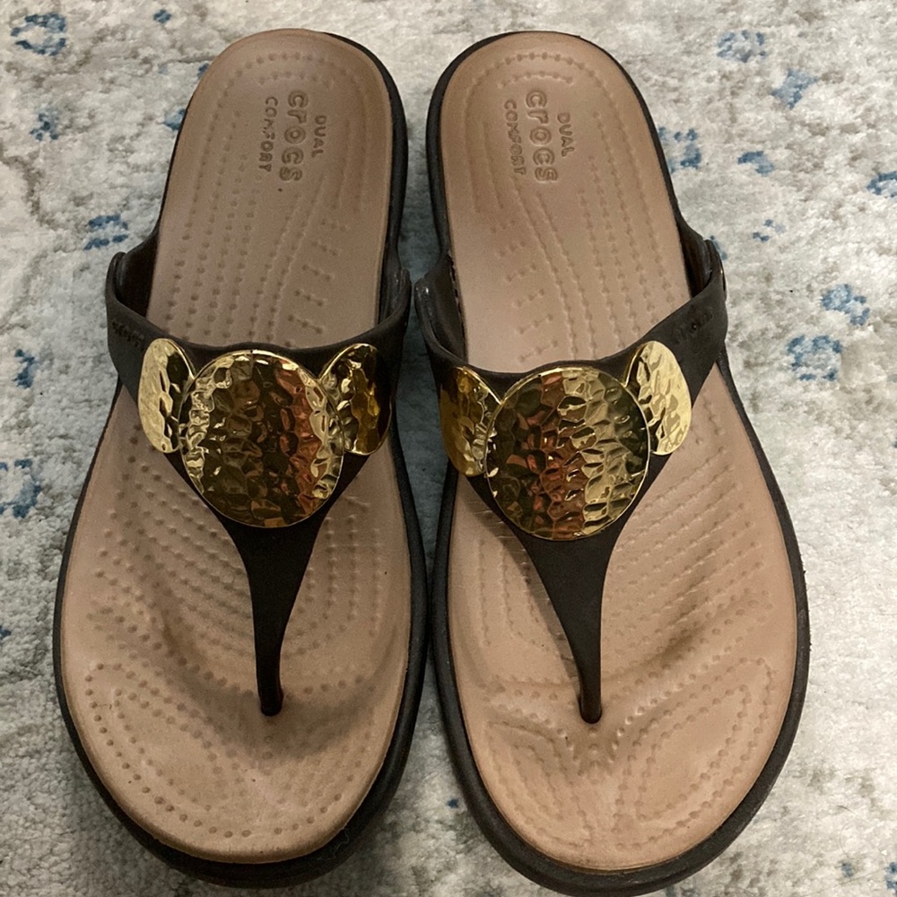 Brown and gold crocs sandals